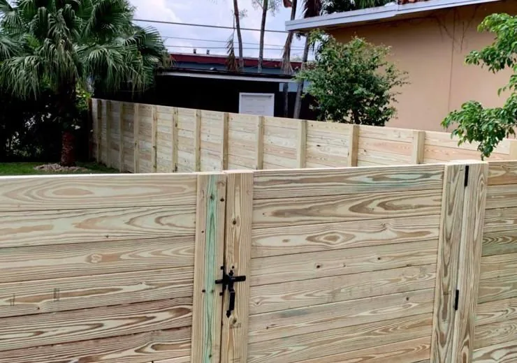 Natural wood privacy fence and matching pedestrian gate