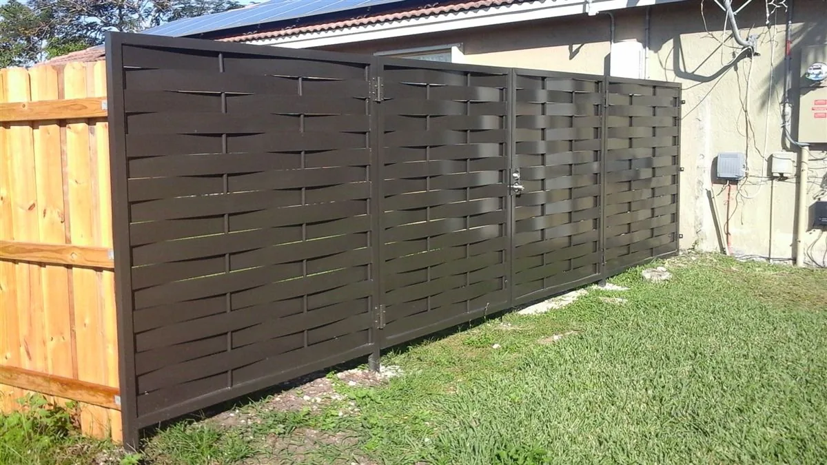 Horizontal wood privacy fence between a lawn and neighboring property